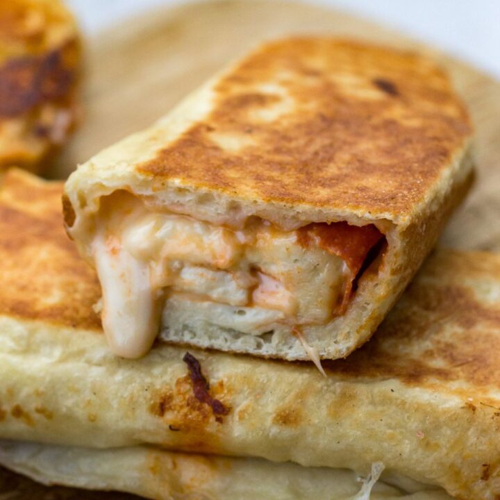 Blackstone stromboli sliced open, showing melted cheese filling.