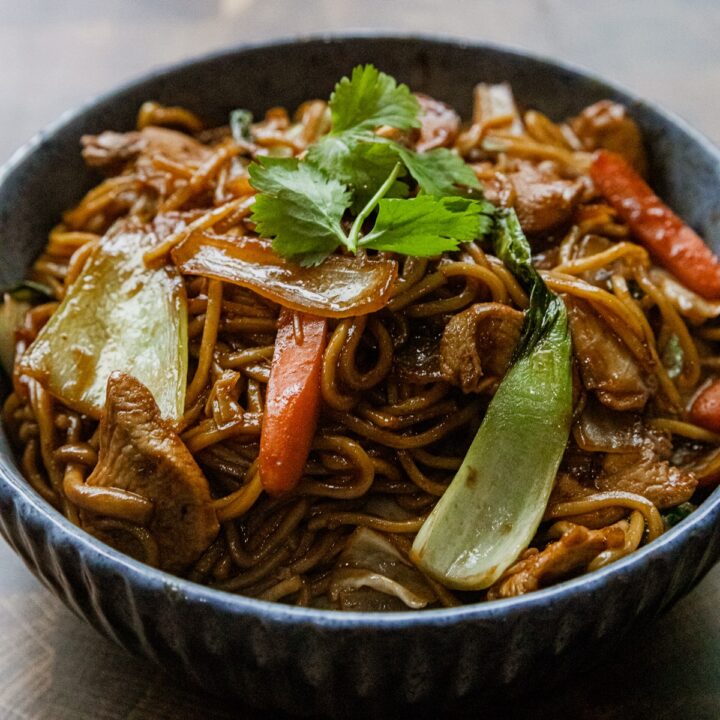 Blackstone chicken yakisoba stir fry with noodles and vegetables.