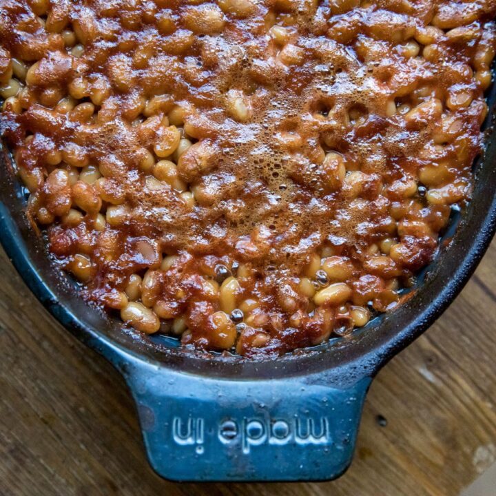 Homemade smoked baked beans in a foil pan, fresh off the Traeger.
