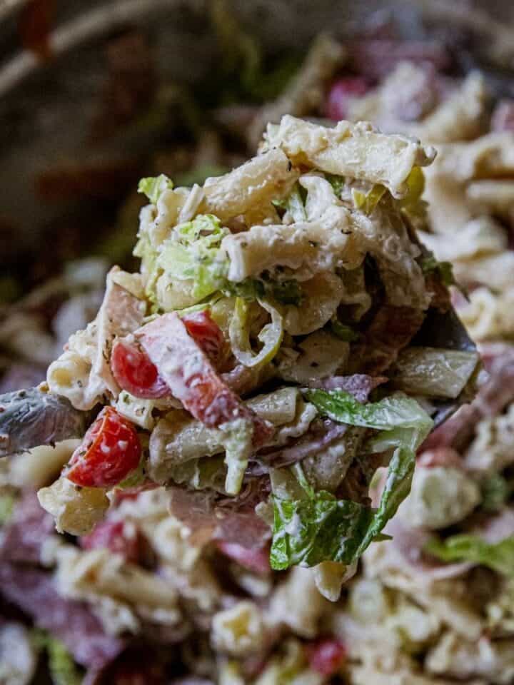 Close-up of Italian grinder pasta salad with vegetables and creamy dressing.