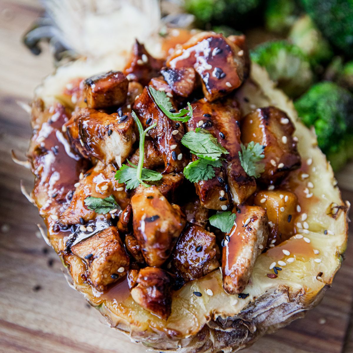 Blackstone pineapple chicken served in a pineapple bowl.
