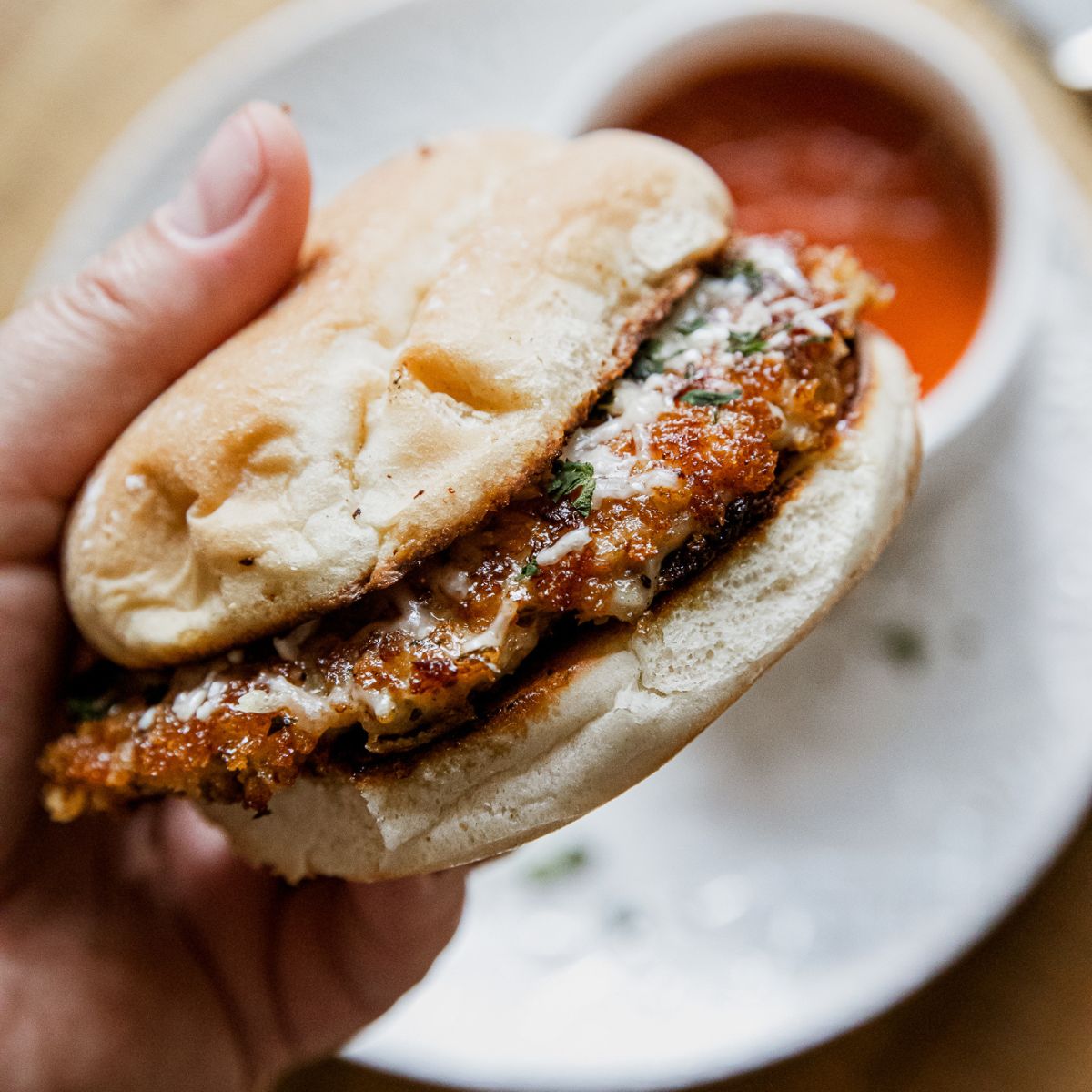 Blackstone smashed chicken parmesan sandwich on a bun.