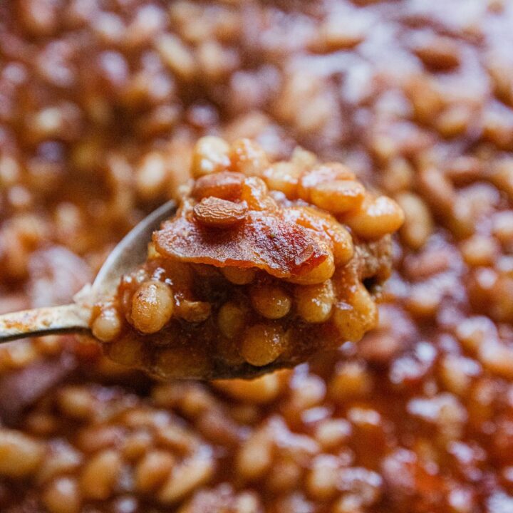 Smoked Dr. Pepper baked beans with bacon in a foil pan.