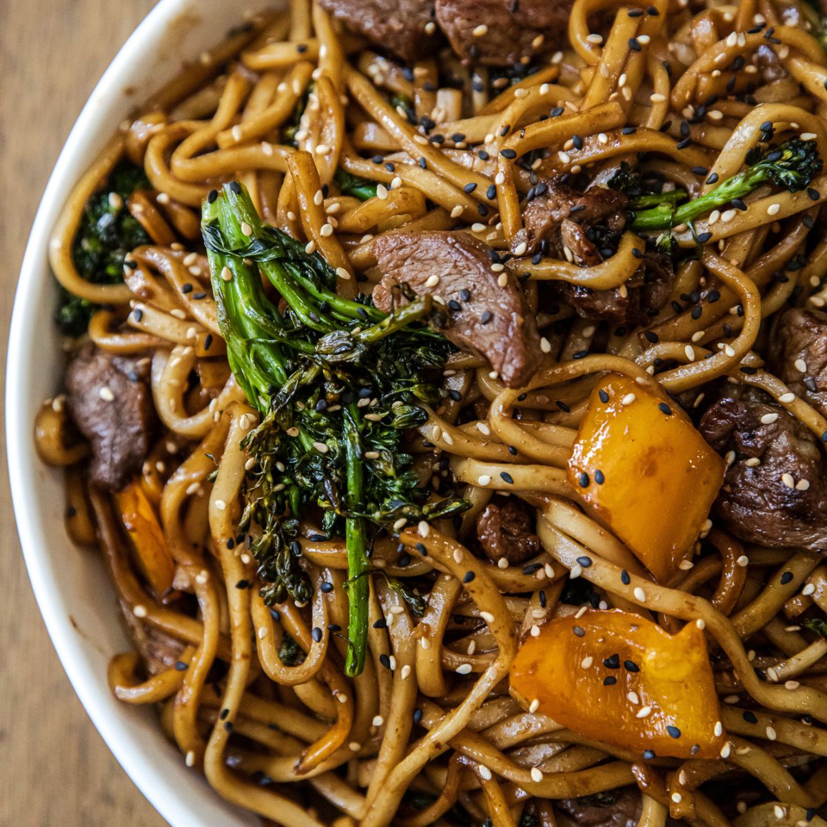 Blackstone steak udon with vegetables on the griddle.