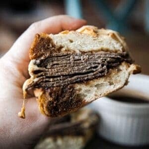 Close-up of a French dip sandwich with beef and bread.