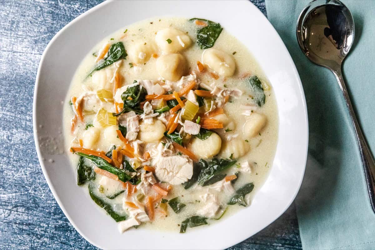 Chicken gnocchi soup in a white bowl